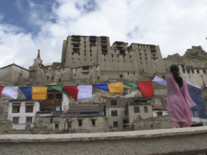 Local team member Sonam Yangzes hosting prayerflags in Leh old town. Local team member Sonam Yangzes hosting prayerflags in Leh old town.