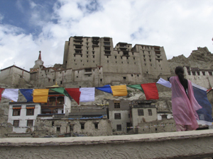 Local team member Sonam Yangzes hosting prayerflags in Leh old town.